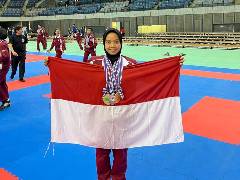 Foto : Atlet karate asal Kecamatan Bua, Kabupaten Luwu, Ildha Yusuf, berpose sambil membentangkan bendera Merah usai bertanding pada ajang The 8th Karate-Do Gojukai Global Championships di Chiba Port Arena, Jepang. (ist).